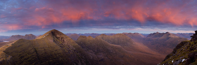 Torridon mountains at dusk. View from Tom na Gruagaich (Beinn Alligin) towards Sgurr Mhor (left), Beinn Dearg (centre) and Liathach (right) taken just after sunset with light reflecting down from clouds. northern Scotland. 